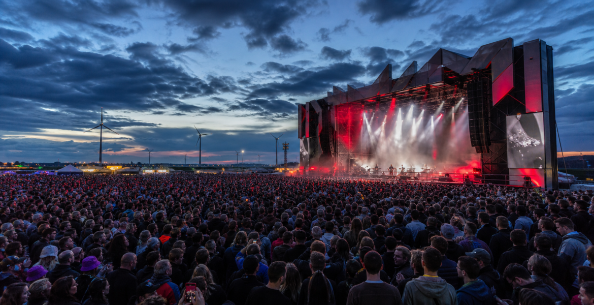 A large crowd watches the final performance at the fictional Aurora Fields festival in the Netherlands.